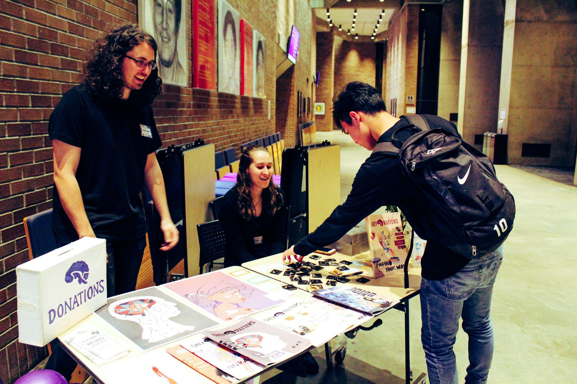 An EWN attendee picks up a black brain keychain from the Grey Matters store.