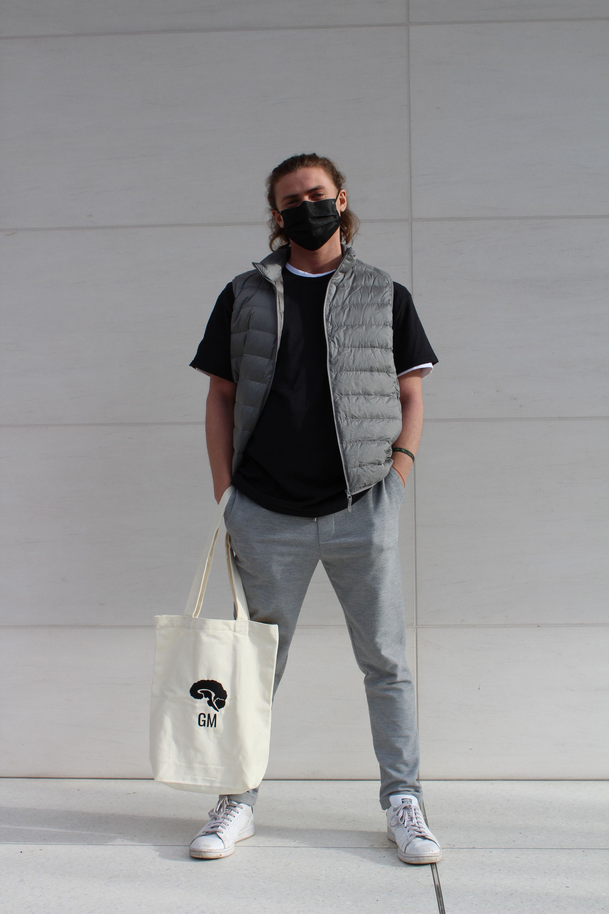 a model holding a Grey Matters tote bag in one hand