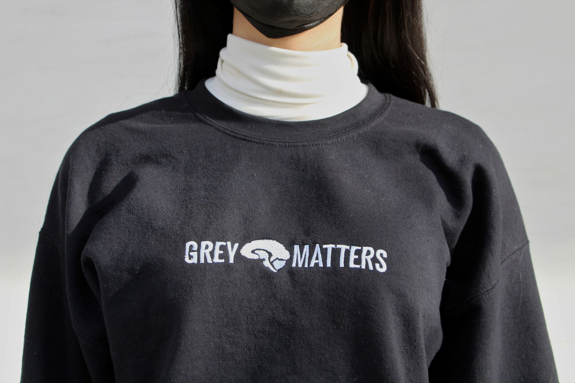 close-up of the Grey Matters logo on the sweatshirt